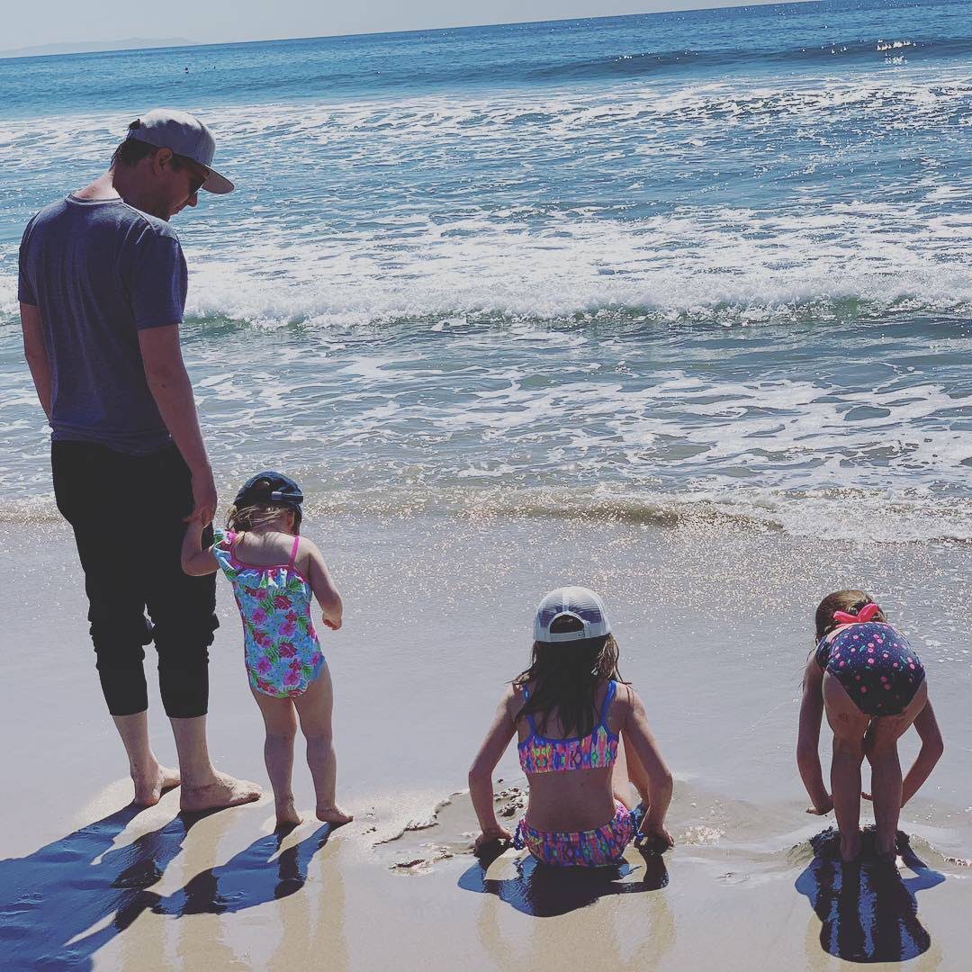 Larry Borins with his three daughters at the beach